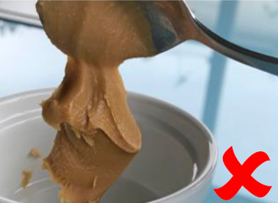 スプーン傾けテストで、ピーナッツバターが付着性の高さによりスプーンに残留している様子